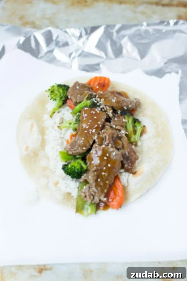 Teriyaki Beef Wraps for a Quick and Easy Dinner Delicious Teriyaki Beef Wraps, a perfect quick dinner with broccoli, carrots, rice, and sesame seeds