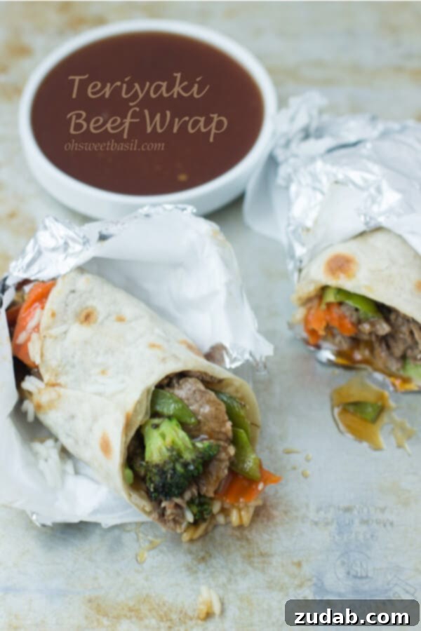 Flavorful Teriyaki Beef Wraps with Fresh Ingredients Close-up of a Teriyaki Beef Wrap showing savory beef, colorful vegetables, and rice wrapped in a tortilla, topped with sesame seeds