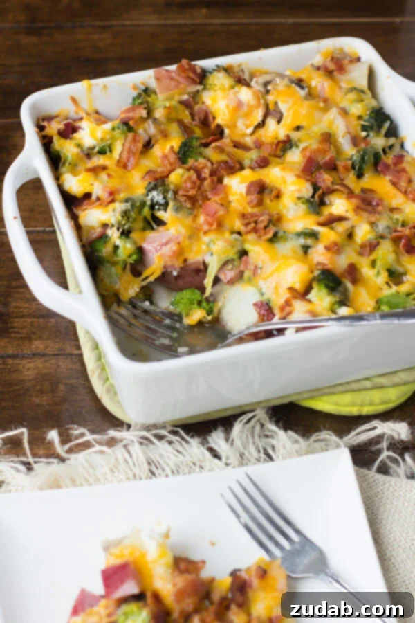 Simple and Delicious Ham and Cheese Casserole A generous serving of cheesy ham and potato casserole, rich with melted cheese, ham, and tender potatoes.