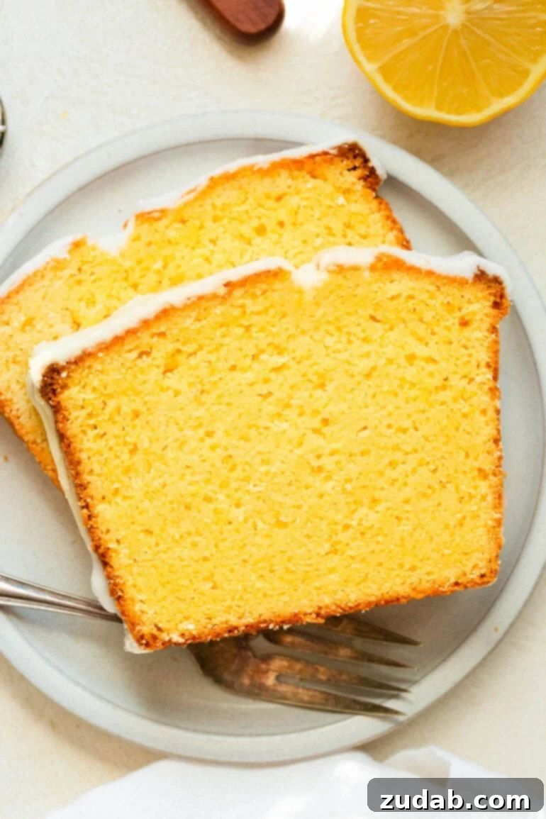 Zesty Lemon Glaze Loaf 2 a photo of two slices of lemon pound cake sitting on a small dessert plate
