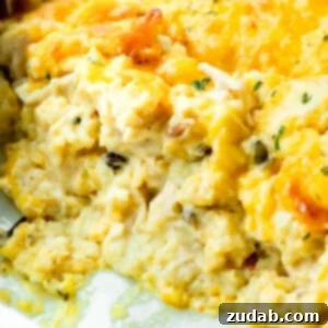 Creamy Dream Chicken & Rice Bake 10 A photo of a chicken and rice casserole in a casserole dish with scoops of the casserole removed