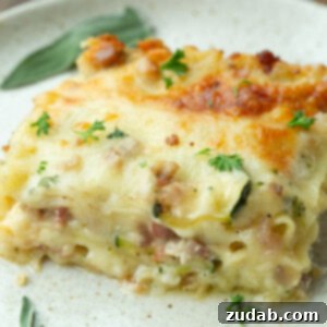 Creamy Vegetable Lasagna with Crispy Pancetta 13 A photo of a serving of white vegetable lasagna being scooped out of a full pan of it