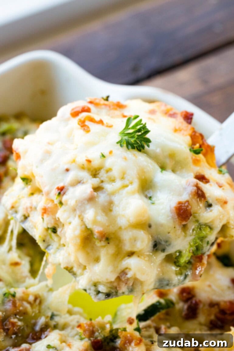 Creamy Vegetable Lasagna with Crispy Pancetta 6 A serving of creamy, golden-baked vegetable white lasagna being scooped out of a full pan, highlighting its rich, cheesy layers and appealing texture.