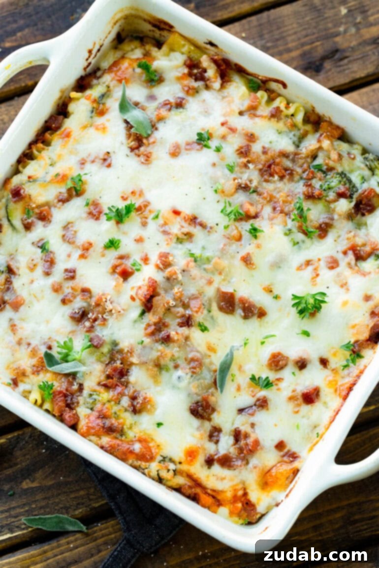 Creamy Vegetable Lasagna with Crispy Pancetta 9 An 8x8 inch white casserole dish filled to the brim with golden-baked pancetta vegetable lasagna with white sauce, ready to be served.