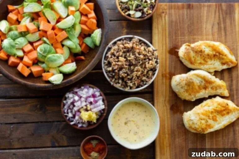 Nourishing Chicken Harvest Bake 4 An overhead shot showcasing all the fresh, colorful ingredients for Healthy Harvest Chicken Casserole in individual bowls, including vibrant Brussels sprouts, diced sweet potatoes, red onion, garlic, and various seasonings