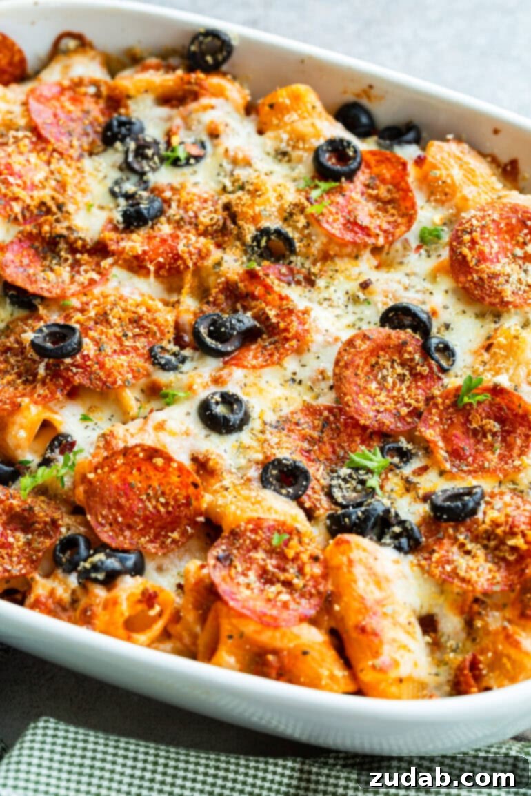 One-Pan Pizza Night Delight 2 a photo of a cheesy pepperoni pasta casserole topped with sliced olives and melted cheese
