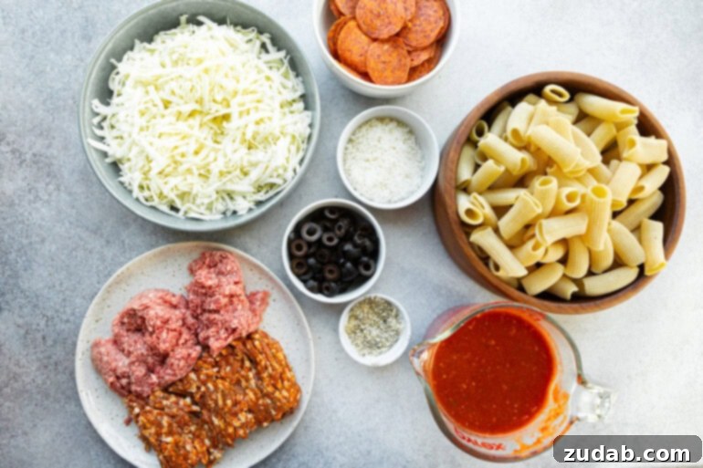 One-Pan Pizza Night Delight 4 a photo of all the ingredients for pizza pasta casserole in separate small bowls including mozzarella cheese, pizza sauce, olives, pepperoni, sausage and ground beef