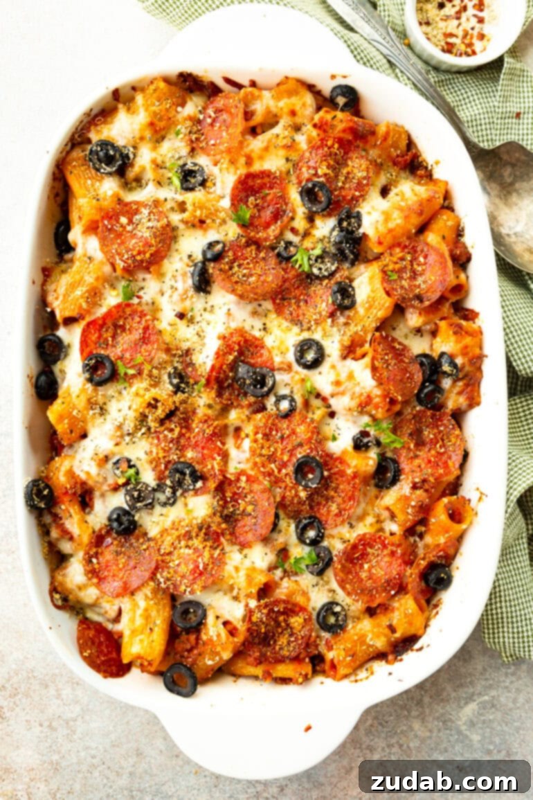 One-Pan Pizza Night Delight 10 a photo of a baked pizza casserole in a white casserole dish