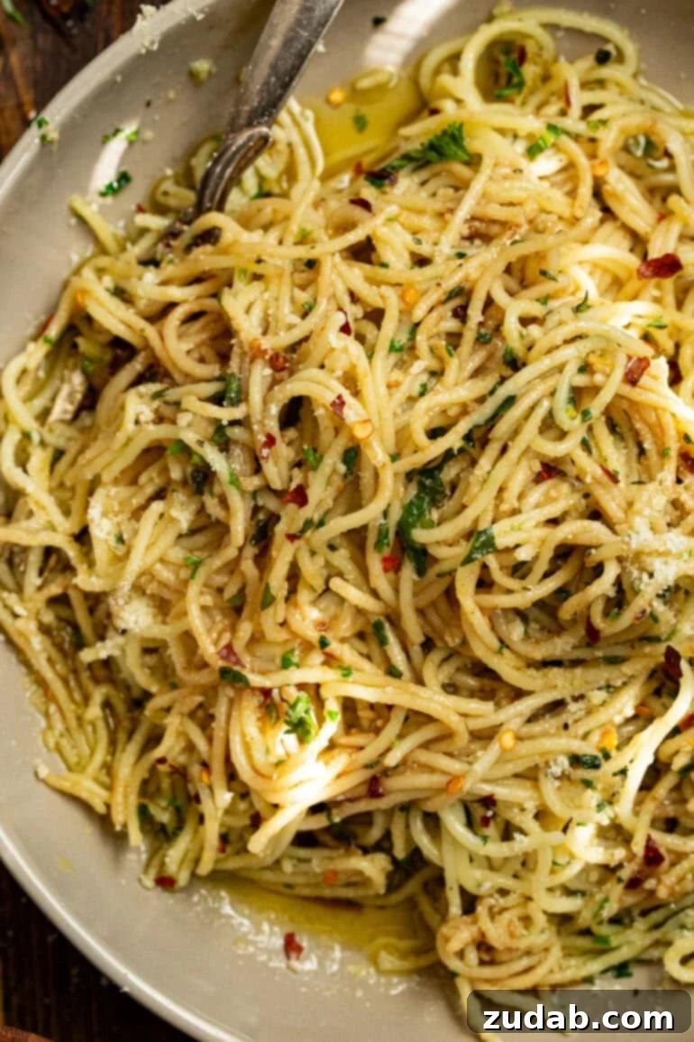 Flavorful Aglio e Olio Made Easy 3 A delicious bowl of spaghetti aglio e olio topped with fresh herbs and a hint of red pepper flakes