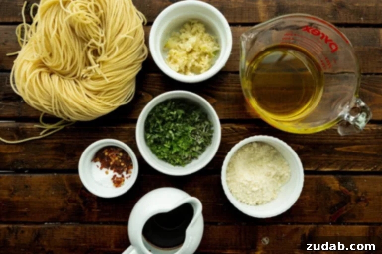 Flavorful Aglio e Olio Made Easy 4 Various ingredients for spaghetti aglio e olio laid out in small bowls, including fresh herbs, garlic, olive oil, and red pepper flakes