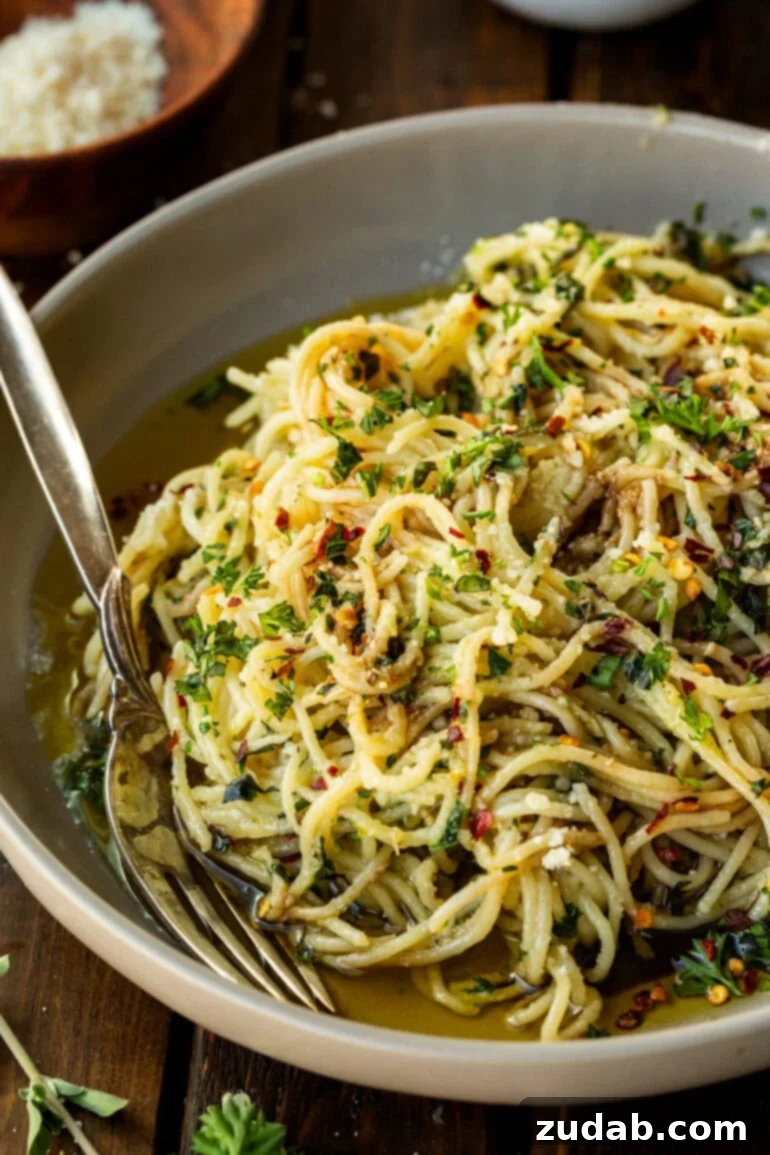 Flavorful Aglio e Olio Made Easy 9 A pristine bowl of spaghetti aglio e olio, crowned with freshly grated Parmesan cheese, glistening with infused oil