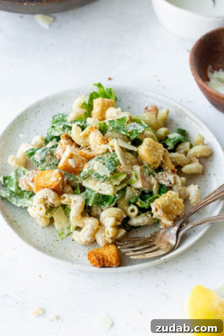 Creamy Chicken Caesar Pasta Salad 7 A dinner plate featuring a generous serving of creamy Chicken Caesar Pasta Salad, topped with crispy croutons.