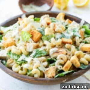 A mouthwatering image of the Chicken Caesar Pasta Salad in a recipe card format.