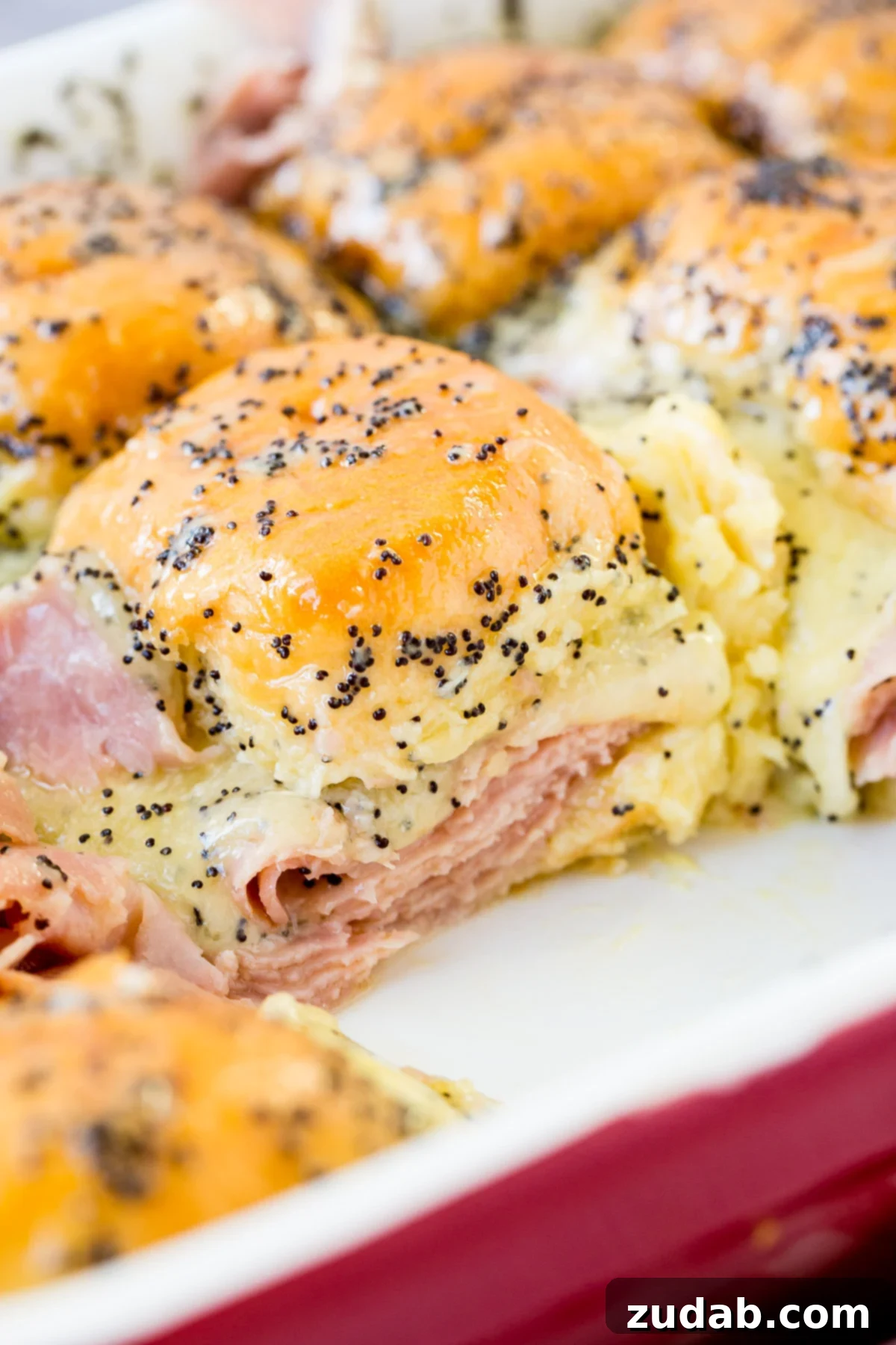 Melty Ham and Cheese Buns 2 Delicious ham and cheese sliders with a savory poppy seed dressing, perfect for using leftover ham.