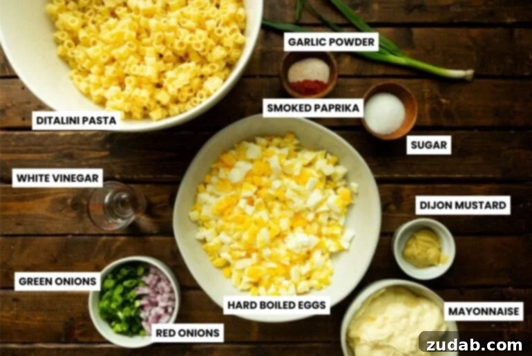 Zesty Deviled Egg Pasta Salad 3 a photo of all the ingredients for deviled egg pasta salad in different bowls on a table
