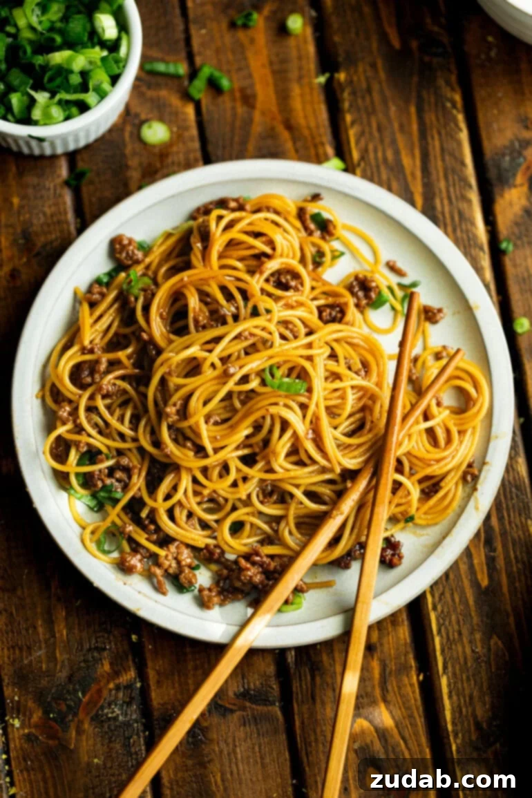 Easy Korean Ground Beef Noodles 7 An inviting top-down view of a single plate generously piled with saucy Korean ground beef noodles, perfectly portioned for a satisfying meal.
