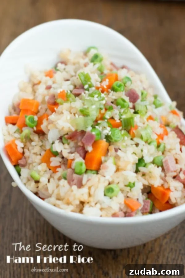 You don't have to even leave your kitchen to have restaurant worthy Chinese food. This is the secret to ham fried rice faux takeout style. A serving of homemade Ham Fried Rice, highlighting the vibrant colors of vegetables and ham.