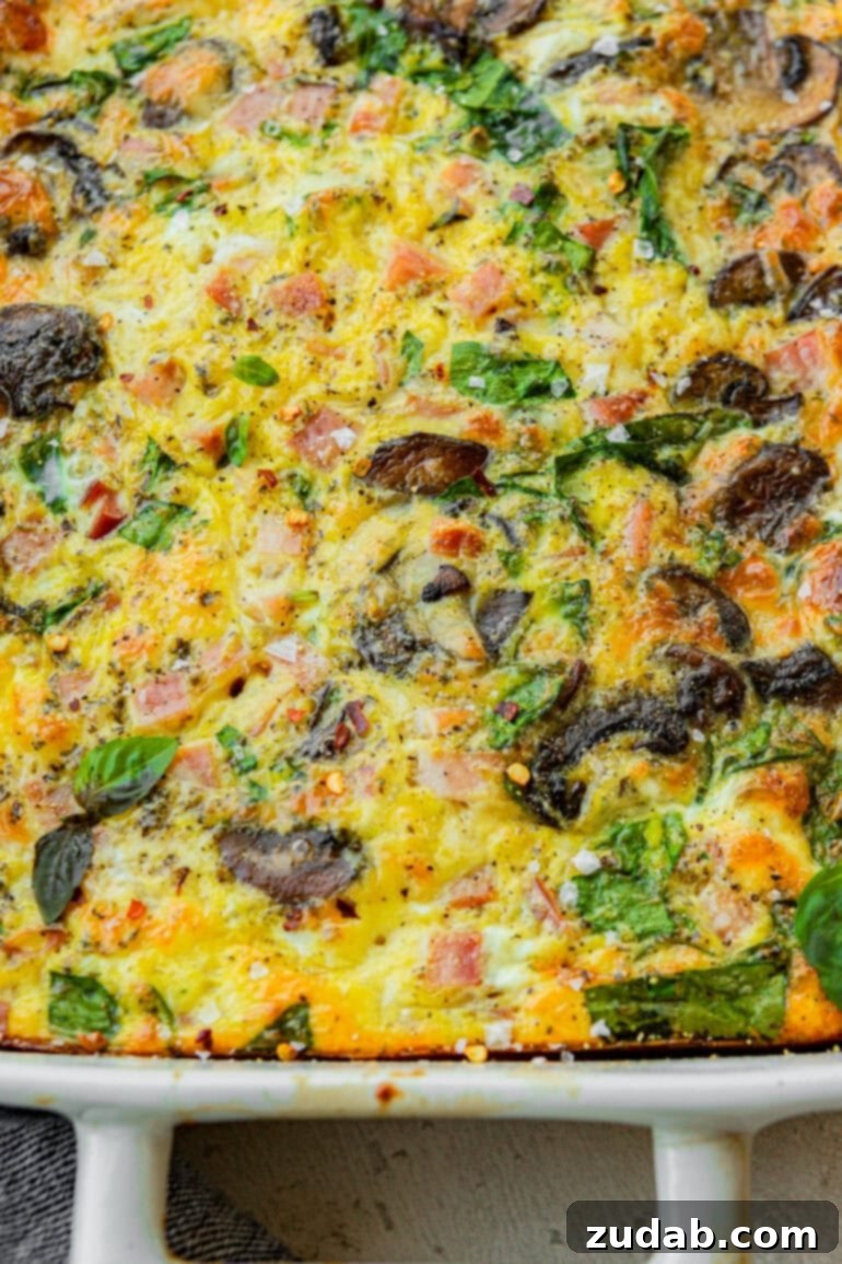 Morning Magic: Ham, Cheese, and Mushroom Egg Bake 3 A baked egg casserole with sautéed mushrooms, spinach, cheese, and diced ham.