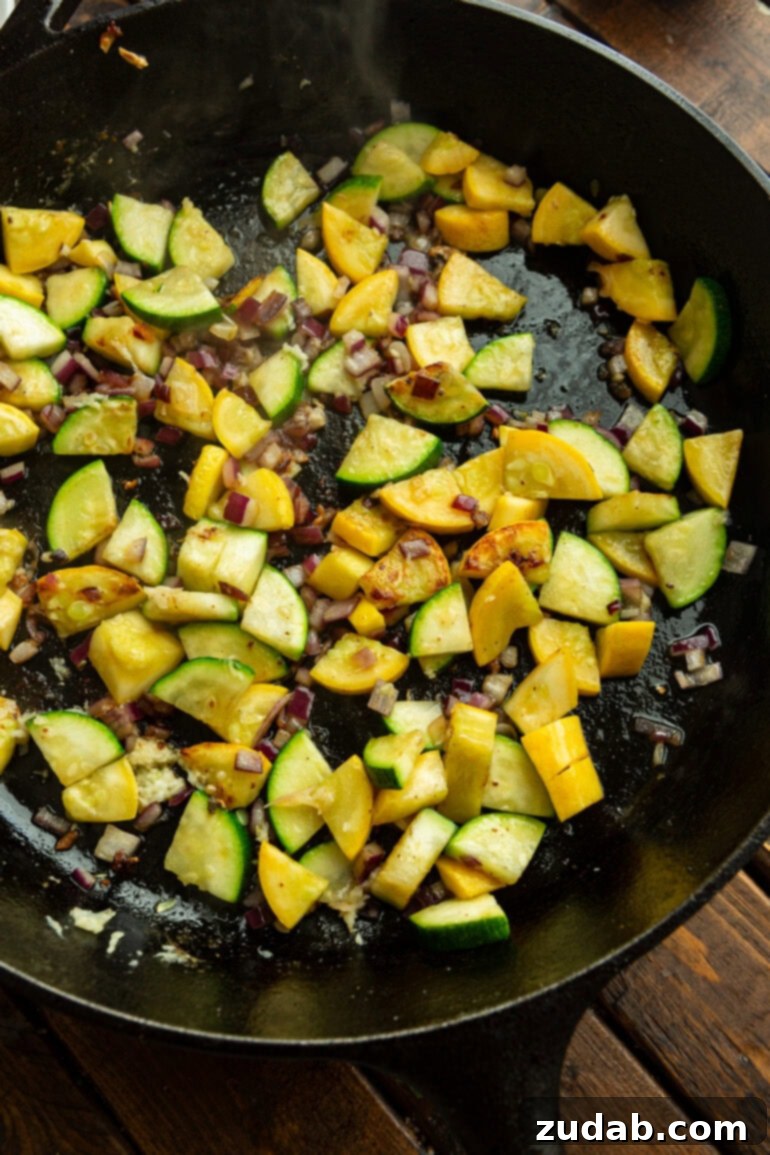 One-Pan Fiesta Chicken & Zucchini Skillet 6 Close-up of vibrant zucchini and yellow squash chunks being perfectly sautéed in a well-seasoned cast iron skillet.