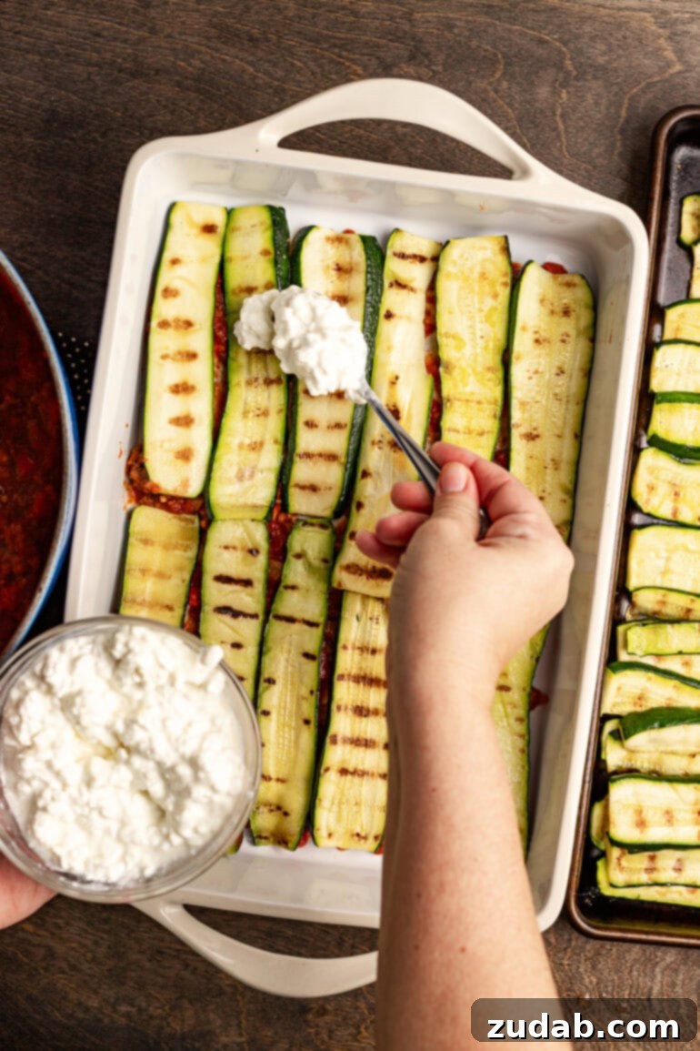 Perfect Zucchini Lasagna No Soggy Layers 10 Adding more meat sauce over the cheese.