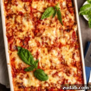 Perfect Zucchini Lasagna No Soggy Layers 16 a pan of cheesy zucchini lasagna with fresh basil leaves on top