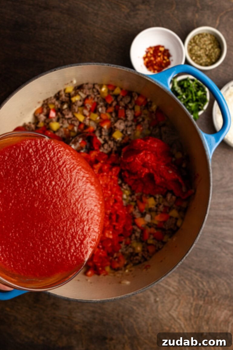Perfect Zucchini Lasagna No Soggy Layers 5 Homemade meat sauce simmering in a pot.
