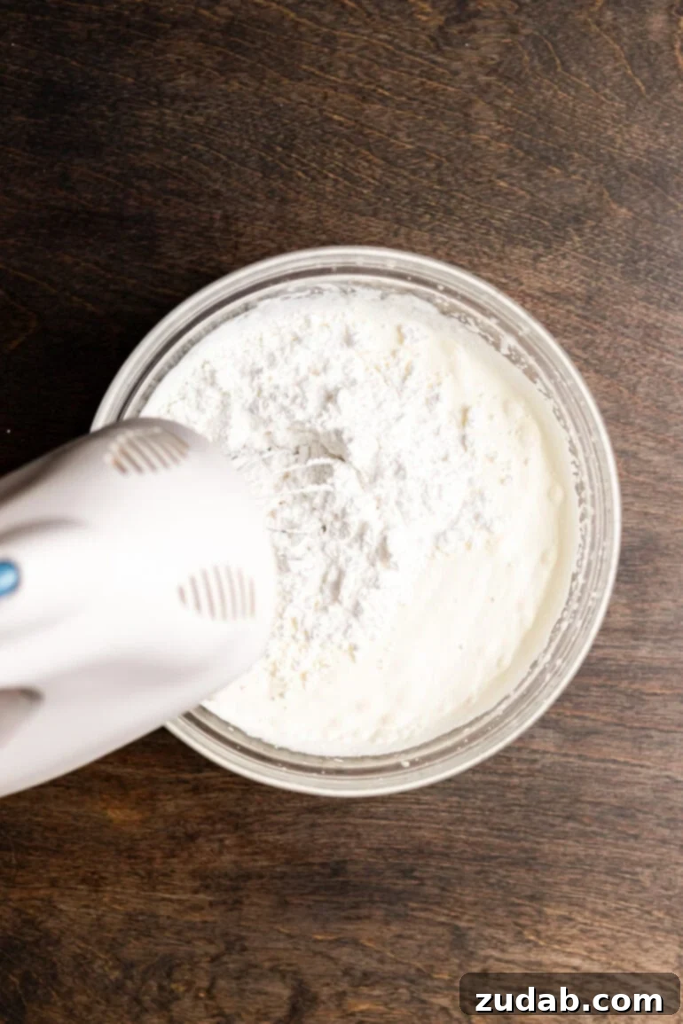 Step 13: Continuing to fold in the remaining whipped cream until fully incorporated and airy.