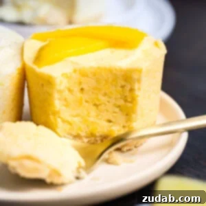 a small frozen mango pie with a fork removing a bite so you can see the cross section of the pie