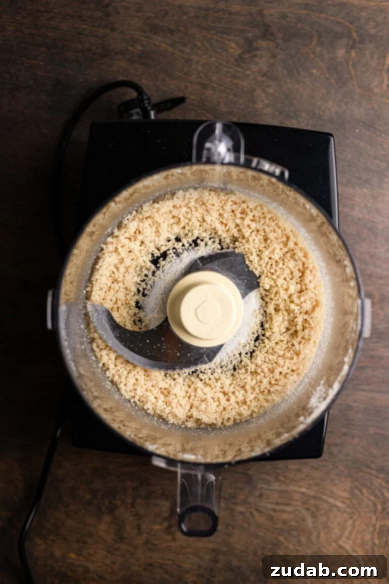 Step 2: Pulsing macadamia nuts and sugar in a food processor for the crust.