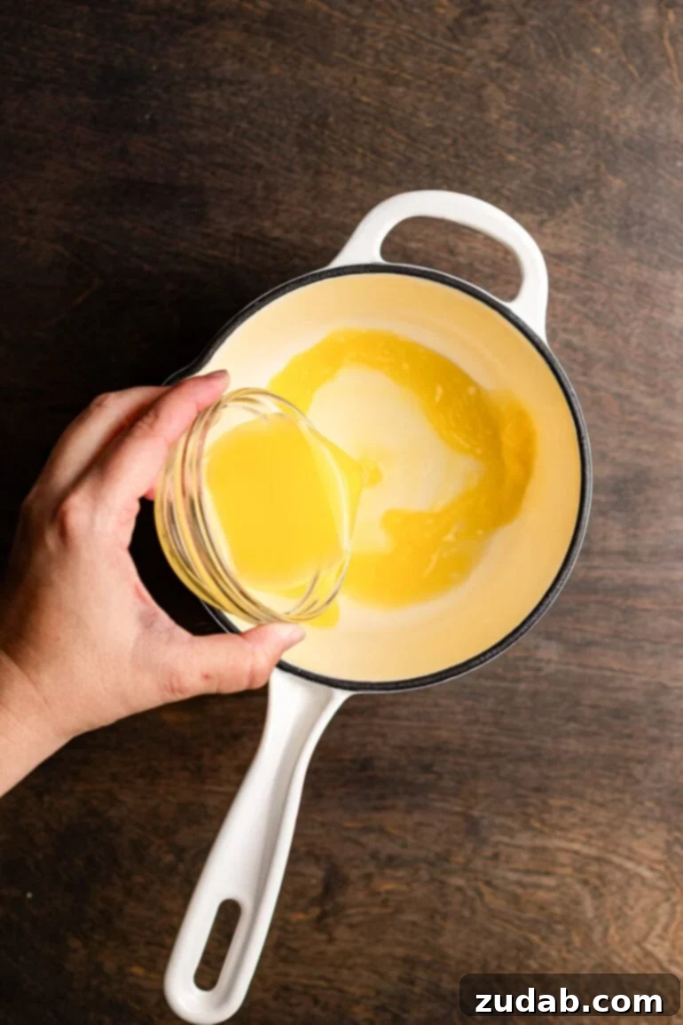 Step 6: Sprinkling gelatin over orange juice to bloom.