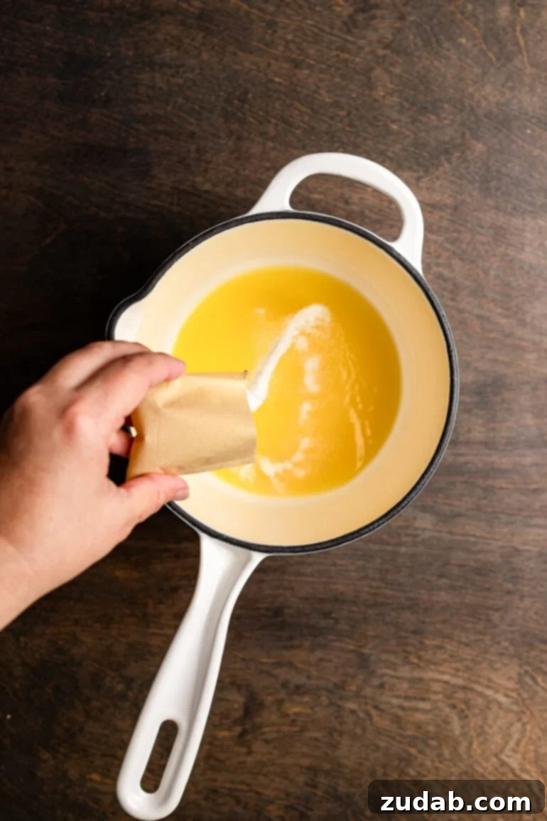 Step 7: Warming the gelatin and orange juice mixture to dissolve gelatin.