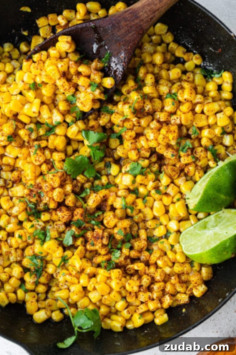 Easy 5-Minute Honey Lime Skillet Corn 5 A close-up of golden corn kernels sizzling in a cast iron skillet with melted butter foaming around the edges, ready to be seasoned.