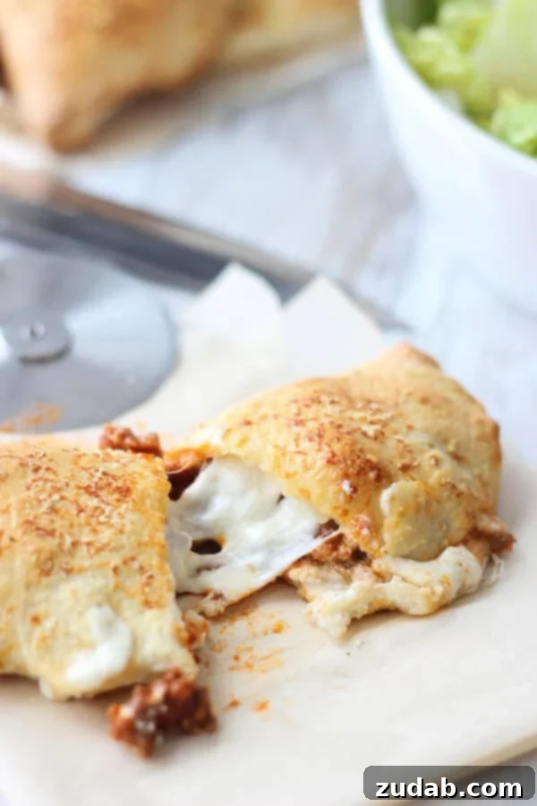 Cheesy Lasagna Calzones with ground sirloin Two freshly baked Cheesy Lasagna Calzones cooling on a wire rack