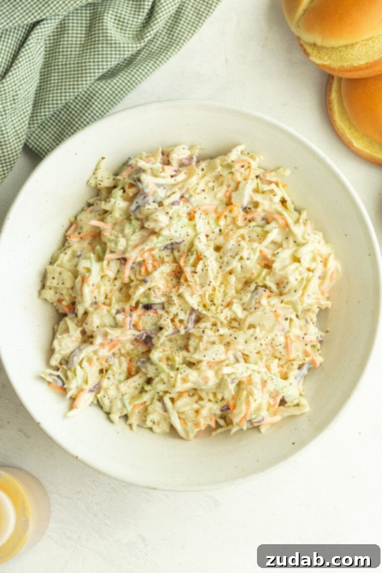 The Secret to Amazing Homemade Coleslaw 4 Freshly tossed creamy coleslaw featuring perfectly shredded cabbage and carrots, with just the right touch of sweetness and tang in every bite.