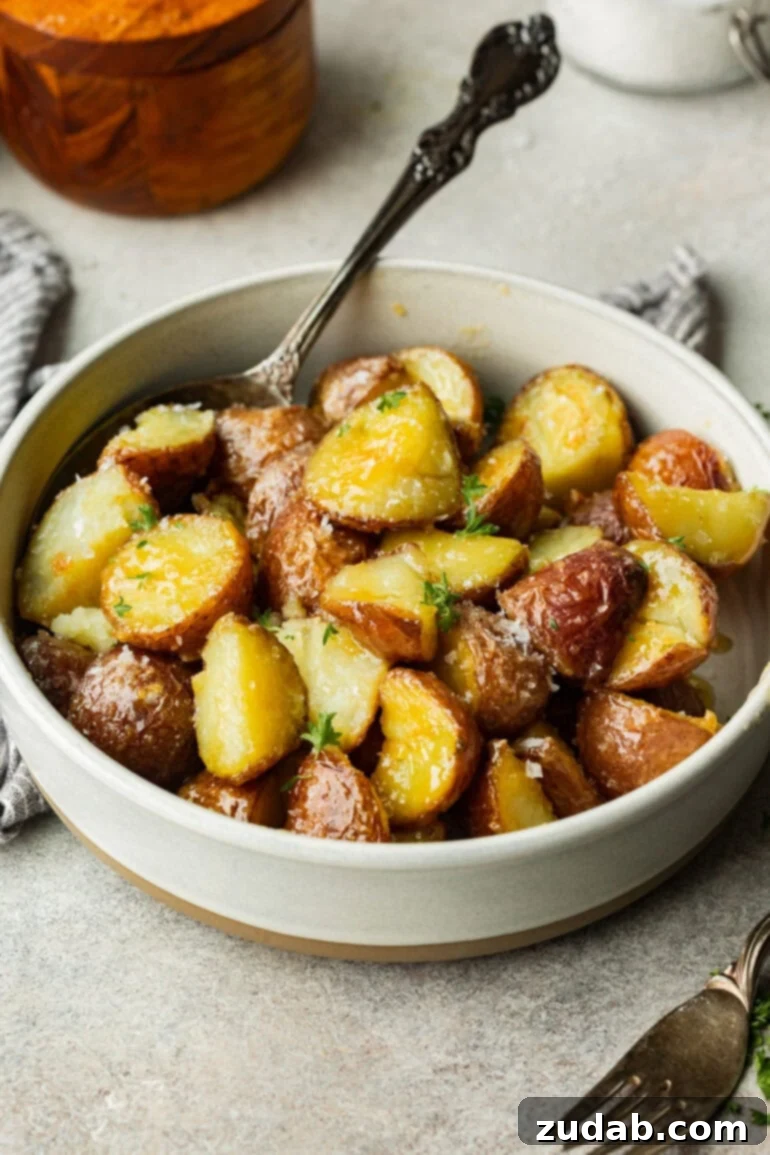 Golden Roasted Red Potatoes 2 A pristine white bowl overflows with golden roasted red potatoes, their skins perfectly crispy and centers wonderfully soft, making them utterly irresistible.