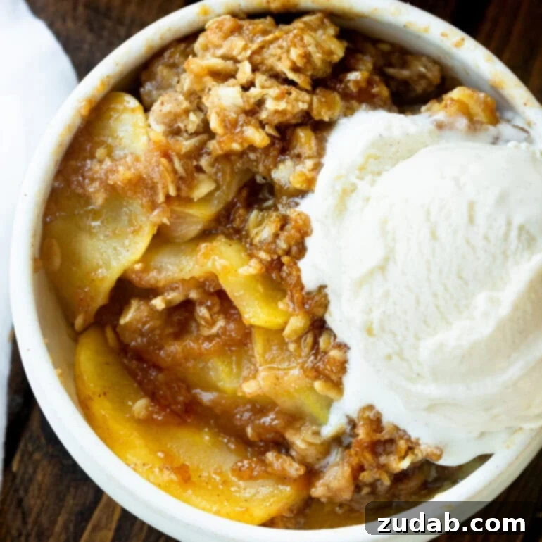 Pumpkin and Apple Perfection: Your Fall Dessert Obsession 14 A warm, bubbling apple crisp with a golden, crunchy oat topping, served in a baking dish.