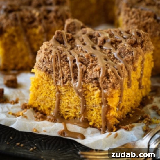 Pumpkin and Apple Perfection: Your Fall Dessert Obsession 4 A slice of Pumpkin Coffee Cake with a generous cinnamon crumb topping, ready to be served.