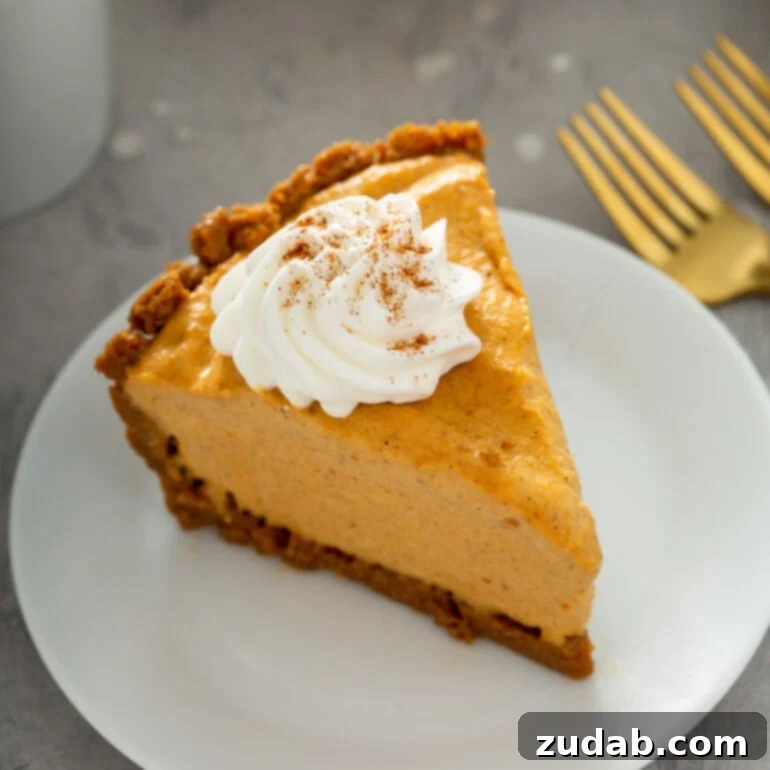 Pumpkin and Apple Perfection: Your Fall Dessert Obsession 5 A festive slice of Pumpkin Ice Cream Pie with a ginger snap crust, garnished with whipped cream, perfect for holiday gatherings.