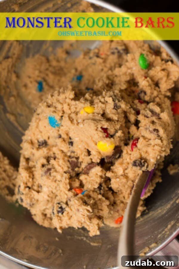 Homemade Monster Cookie Bars: Peanut Butter, Oats, M&M's, and Chocolate Chips Close-up of freshly baked Monster Cookie Bars, showing their delightful texture and colorful M&M's.