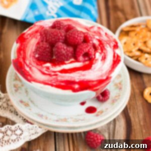 The best no-bake raspberry cheesecake dip, incredibly creamy and irresistible. Made with cream cheese, marshmallow, and raspberry jam.