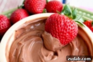 Luscious Raspberry Cheesecake Dip 6 A vibrant bowl of healthy chocolate dip, paired with fresh strawberries, suggesting a light and nutritious dessert option. Emphasizes healthy eating without sacrificing flavor.