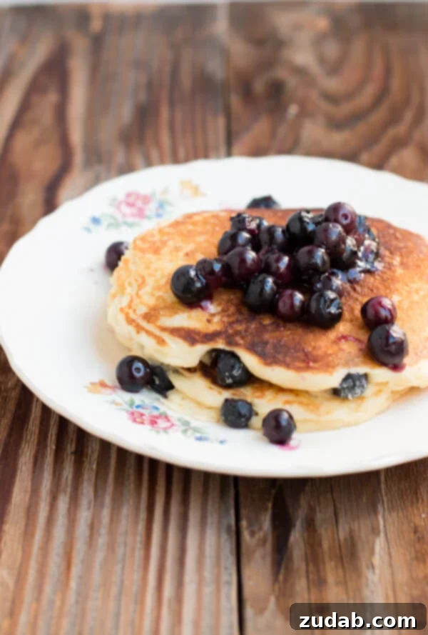 Perfectly Cooked White Chocolate Blueberry Pancakes Stack of White Chocolate Blueberry Pancakes with Syrup