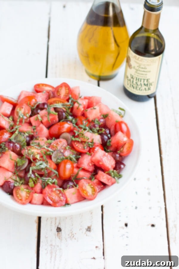 The BEST watermelon salad with mint recipe we've made ohsweetbasil.com Vibrant Watermelon Salad with Mint and Grapes, a healthy and easy summer recipe that everyone will love from ohsweetbasil.com