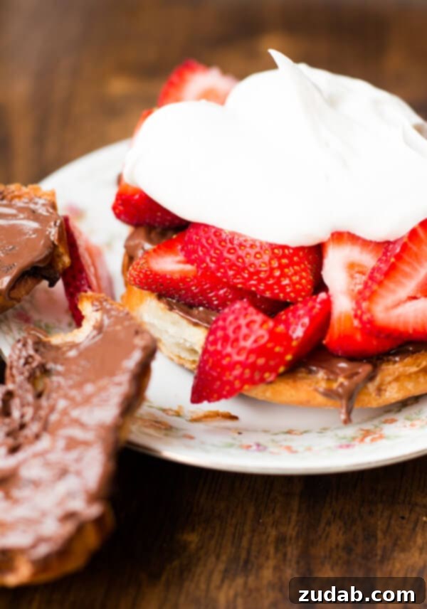 Assembling the Grilled Nutella Strawberry Croissant A hand gently topping a grilled croissant with freshly whipped cream, highlighting the dessert's assembly.