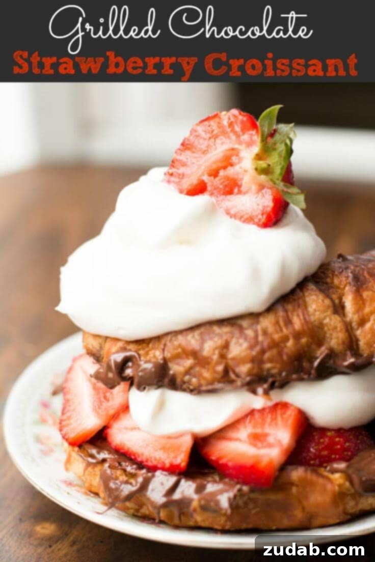 Grilled Hazelnut Spread and Strawberry Croissants - Top View A stunning overhead shot of two grilled Nutella strawberry croissants, showcasing the rich fillings and toppings on a rustic surface.