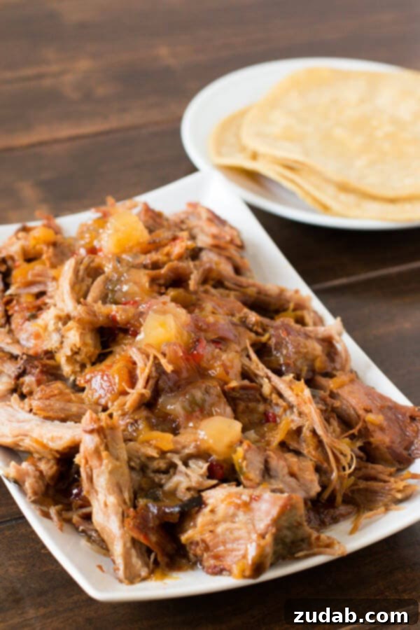 Slow Cooker Pineapple Habanero Pork: Easy 3-Ingredient Recipe Tender slow cooker pineapple habanero pork, a perfect blend of sweet and savory with a mild kick. Ideal for tacos, sandwiches, or rice bowls, showcasing the rich, glistening sauce.