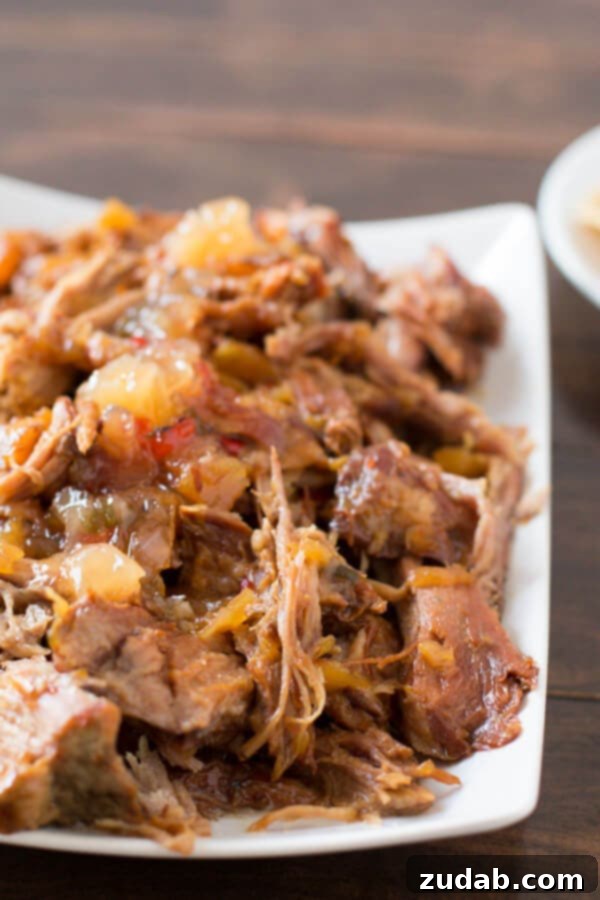 Delicious Pineapple Habanero Pulled Pork Close-up of perfectly shredded pineapple habanero pork, showcasing its rich, sticky glaze and incredibly tender texture, ready for a delicious and versatile meal.