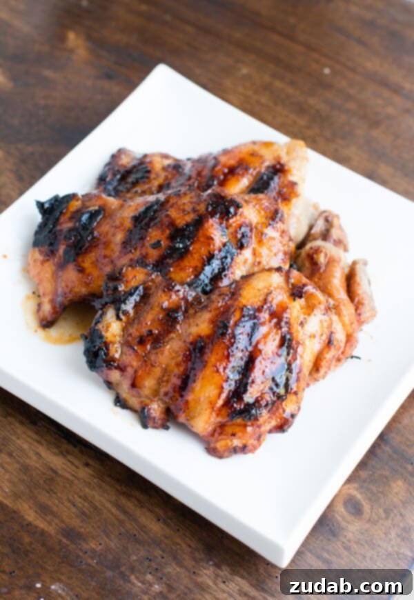 Oh my goodness, this chicken!! Sticky honey lime grilled chicken is our new favorite! ohsweetbasil.com A platter of beautifully grilled sticky honey lime chicken thighs ready to be served.