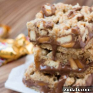 Close-up of a square Twix Caramelita bar with visible layers of oats, chocolate, and caramel.