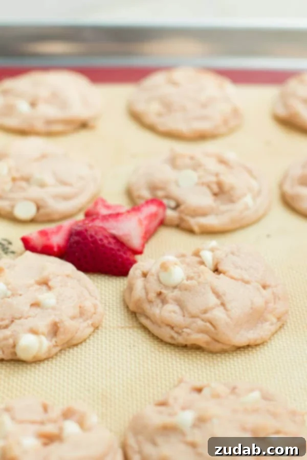 Perfectly soft Strawberries and Cream Pudding Cookies Close-up of a perfectly baked Strawberries and Cream Pudding Cookie, highlighting its pink hue and soft interior.